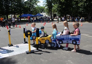 Dzieci mają założone autochodziki i poruszają się po wyznaczonej trasie